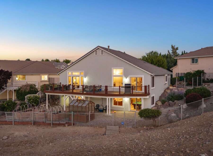 Experience luxurious outdoor living with this stunning backyard featuring a spacious multi-level deck perfect for entertaining.