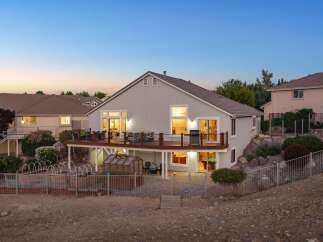 Experience luxurious outdoor living with this stunning backyard featuring a spacious multi-level deck perfect for entertaining.