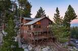 Nestled amidst towering pine trees and natural rock formations, this multi-level wooden home offers breathtaking views and ample outdoor living space.