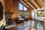 Experience rustic charm in this mountain retreat featuring a stunning stone fireplace and soaring vaulted ceilings with exposed wooden beams.