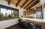 Experience breathtaking mountain views from this stunning kitchen, featuring a spacious granite countertop island perfect for casual dining.