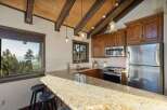 Experience breathtaking mountain views from this charming kitchen, featuring a spacious granite countertop island perfect for casual dining.