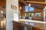 Experience breathtaking mountain views from this stunning living space, featuring a cozy fireplace and expansive windows that flood the room with natural light.