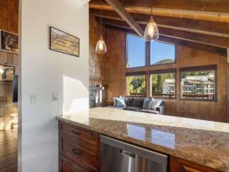 Experience breathtaking mountain views from this stunning living space, featuring a cozy fireplace and expansive windows that flood the room with natural light.