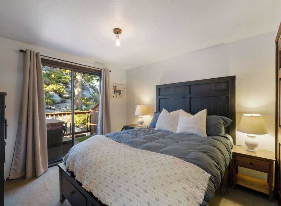 Experience ultimate relaxation in this serene bedroom, featuring a comfortable king-size bed adorned with plush pillows and a cozy duvet.