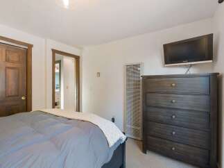 This cozy bedroom features a comfortable bed with a plush duvet and a decorative throw.