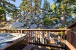 Enjoy ultimate relaxation in this stunning property featuring a luxurious hot tub overlooking a picturesque rocky hillside dotted with mature pine trees.