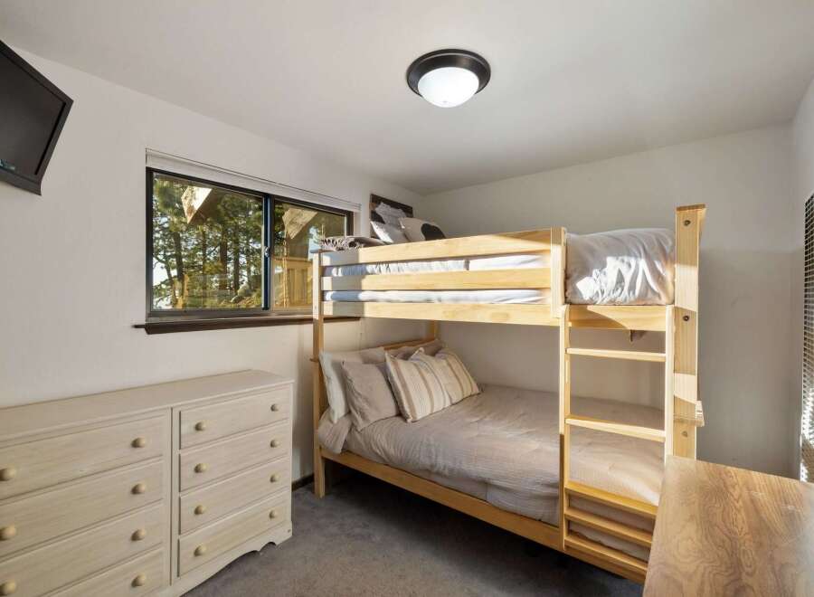 This cozy bedroom features a space-saving bunk bed, perfect for accommodating guests or children.