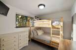 This cozy bedroom features a space-saving bunk bed, perfect for accommodating guests or children.
