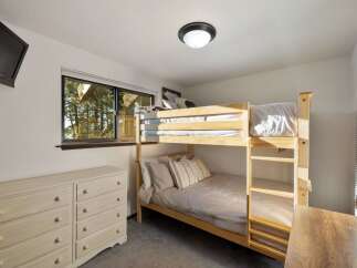 This cozy bedroom features a space-saving bunk bed, perfect for accommodating guests or children.