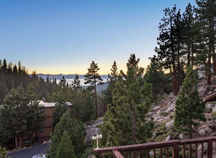 Experience breathtaking lake and mountain views from this stunning property nestled among pine trees.