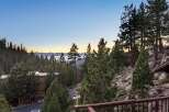 Experience breathtaking lake and mountain views from this stunning property nestled among pine trees.