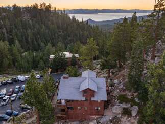Nestled amidst a dense pine forest with a stunning lake view, this property offers a unique mountain retreat.