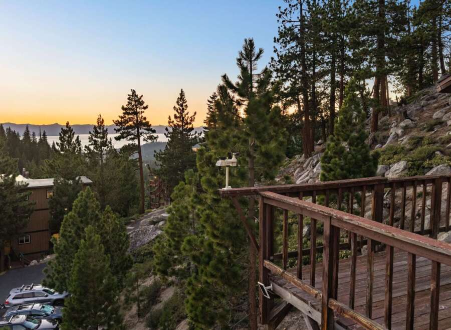 Experience breathtaking lake and mountain views from this stunning property, nestled amongst tall pine trees.