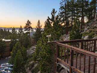 Experience breathtaking lake and mountain views from this stunning property, nestled amongst tall pine trees.