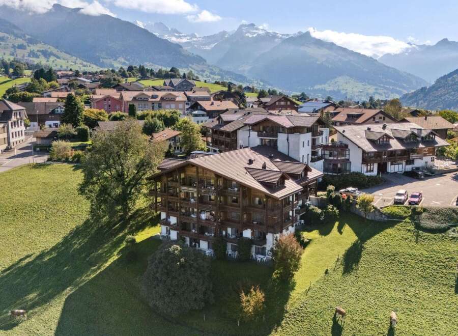 Experience breathtaking mountain views from this stunning alpine property, featuring traditional wooden architecture and spacious balconies perfect for enjoying the scenery.