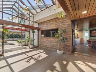 Step into a welcoming lobby featuring a stunning glass ceiling that floods the space with natural light.