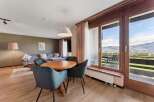 Experience breathtaking mountain views from this charming living and dining area.