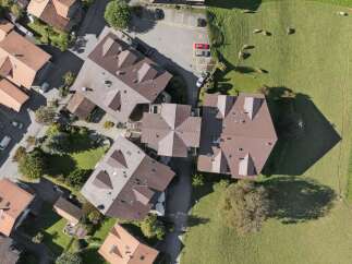 Discover this stunning aerial view of a residential area featuring modern homes with distinctive brown tile roofs.