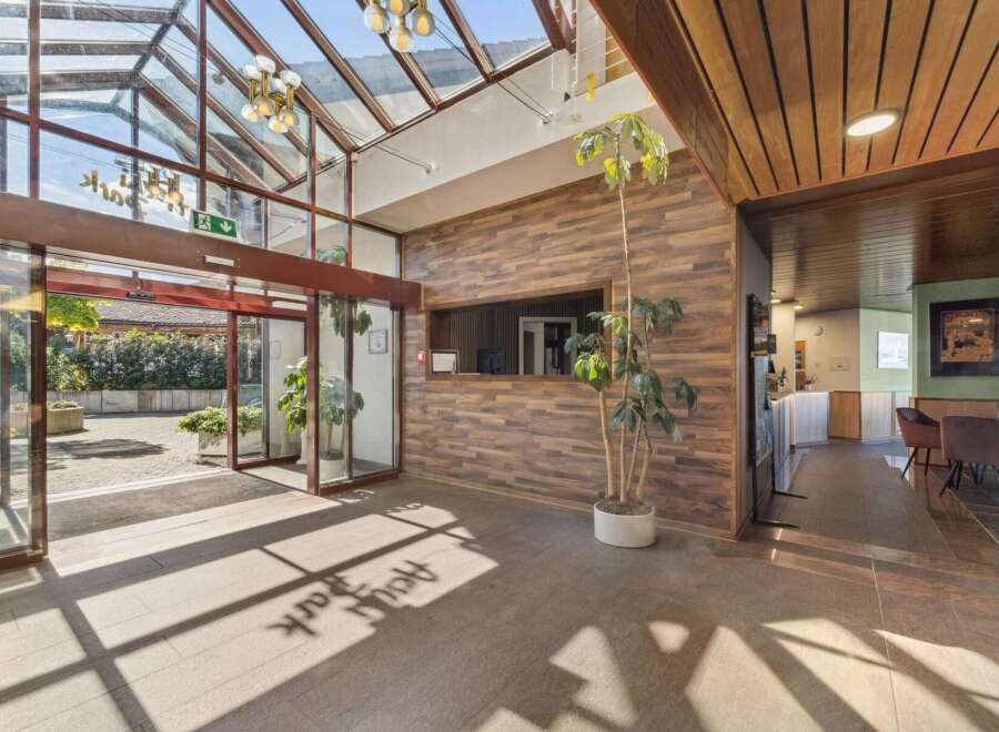 Step into a welcoming lobby featuring a stunning glass ceiling that floods the space with natural light.