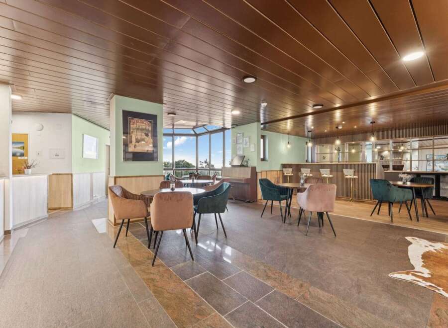 Step into this inviting lounge area, featuring a stylish bar perfect for socializing and enjoying a drink.
