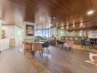 Step into this inviting lounge area, featuring a stylish bar perfect for socializing and enjoying a drink.