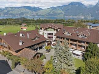 Experience breathtaking mountain and lake views from this stunning property, featuring charming alpine architecture and spacious balconies.