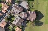 Discover this stunning aerial view of a residential area featuring modern homes with distinctive brown tile roofs.