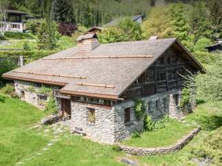 Discover this charming stone and wood chalet nestled in a serene, wooded setting.