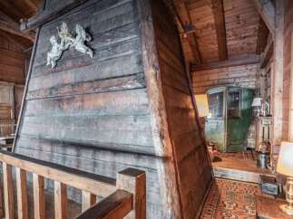 Step into a unique rustic retreat featuring a grand wooden fireplace as the centerpiece of this charming interior.