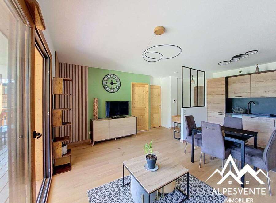 Discover this modern living space featuring a vibrant green accent wall adorned with a large clock and a sleek entertainment center.