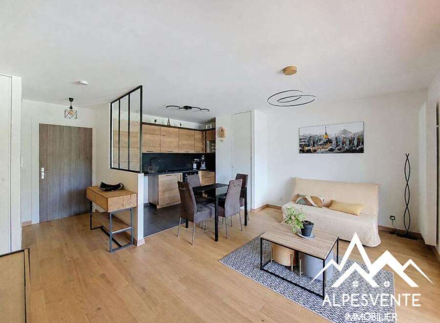 Discover this bright and modern open-plan living space, featuring a sleek kitchen with ample cabinetry and a comfortable living area perfect for relaxation.