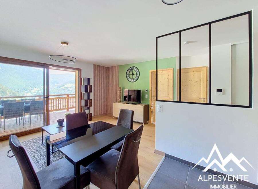 Experience modern living in this spacious dining and living area, featuring a sleek black dining table set for intimate gatherings.