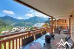 Enjoy breathtaking mountain views from this stunning balcony, perfect for al fresco dining or relaxing with a cup of coffee.