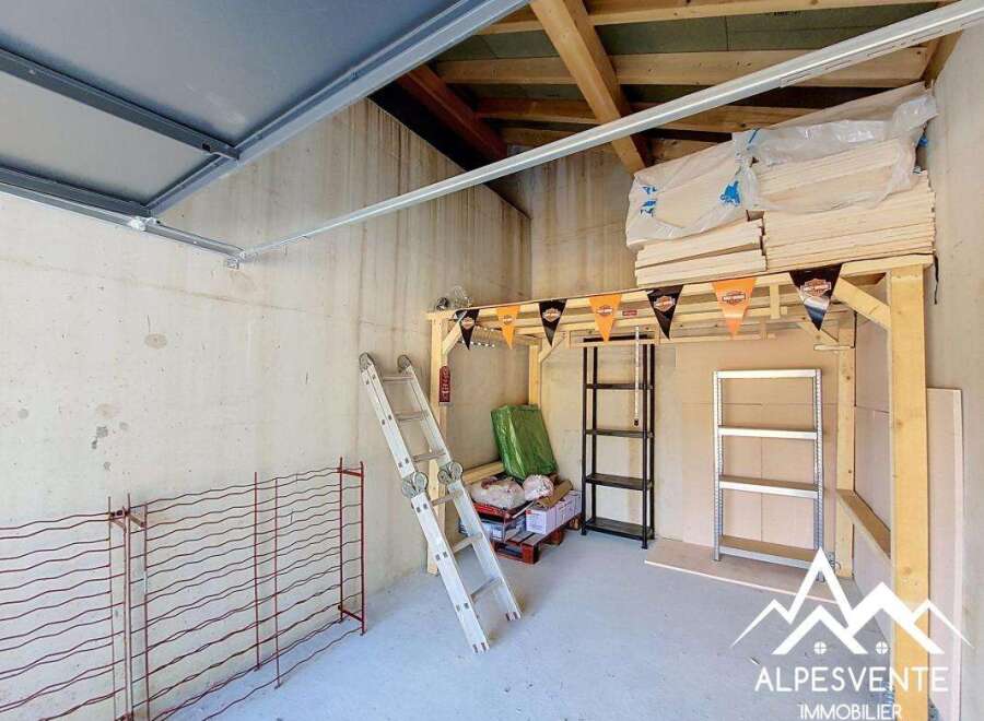 Discover this versatile space, perfect for storage or a workshop, featuring ample shelving and a sturdy ladder for easy access.