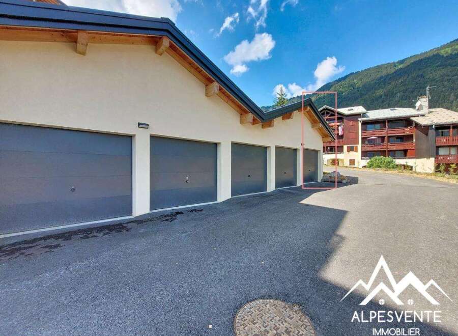Discover this property featuring a row of modern garages with sleek, dark gray doors, perfect for secure vehicle storage.