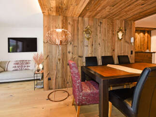 Experience rustic charm in this inviting dining area, featuring a warm wooden ceiling and walls that exude alpine coziness.