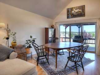 Experience comfortable living in this inviting dining area, featuring a spacious oval dining table perfect for family gatherings.