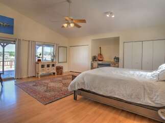 Experience comfort and style in this spacious bedroom, featuring a cozy fireplace and a private balcony with scenic views.