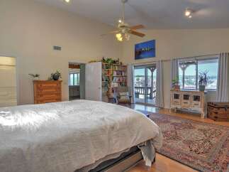 This spacious bedroom offers a vaulted ceiling with a ceiling fan, creating an airy and open atmosphere.