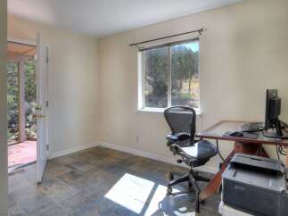 This home office features a comfortable ergonomic chair and a functional desk setup with a computer and printer.