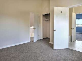Step into this spacious bedroom featuring plush carpeting and ample closet space for all your storage needs.