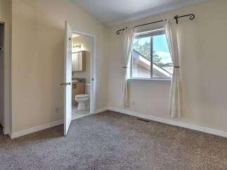 This charming bedroom features a spacious closet and an en-suite bathroom for added convenience.
