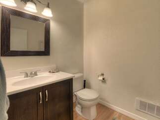 This bathroom features a modern vanity with a sleek faucet and a large mirror, perfect for your morning routine.