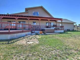 Enjoy outdoor living with this spacious deck featuring a covered pergola and a relaxing hot tub, perfect for unwinding.