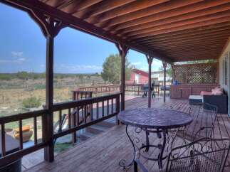 Enjoy the stunning outdoor living space with this expansive covered deck, perfect for entertaining or relaxing.