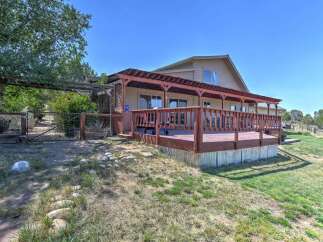 Enjoy outdoor living with this expansive wooden deck, perfect for entertaining or relaxing.