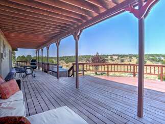 Enjoy outdoor living on this expansive covered deck, perfect for entertaining or relaxing with a view.