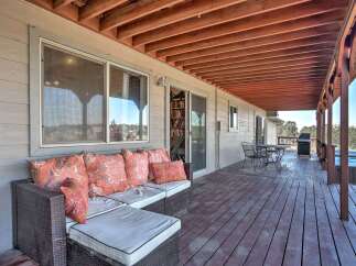 Enjoy outdoor living on this spacious covered deck, perfect for entertaining or relaxing.
