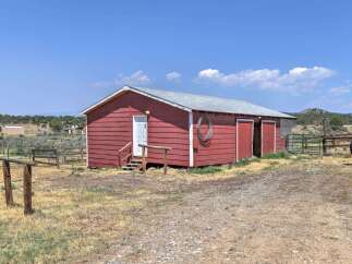Discover this charming red barn, perfect for agricultural pursuits or as a versatile storage solution.